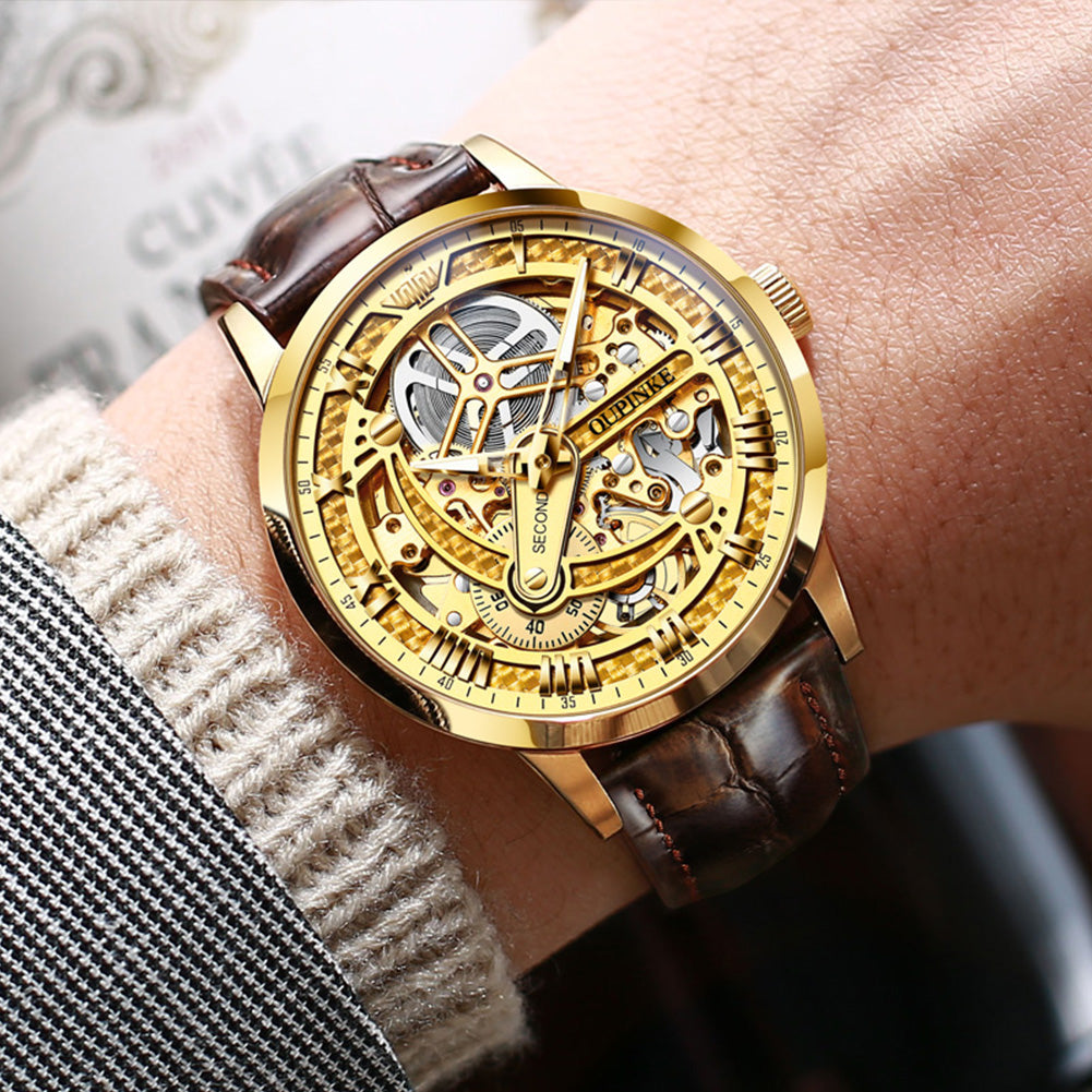 OUPINKE 3173 gold automatic skeleton watch on brown leather strap worn on wrist