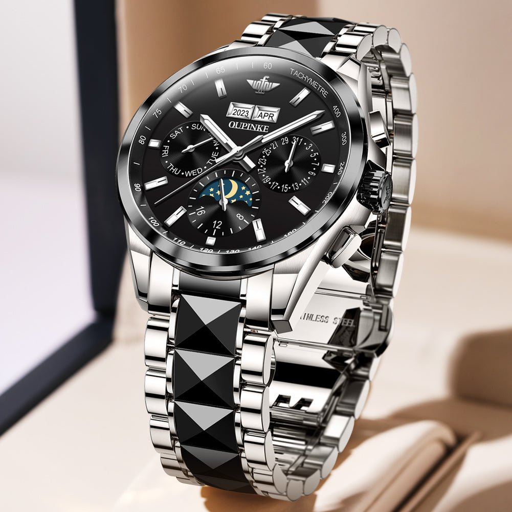 Silver watch with black face on a light background